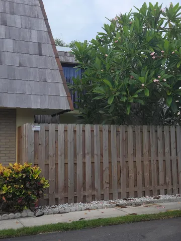 a view of a backyard with wooden fence