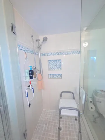 a bathroom with a refrigerator and a sink