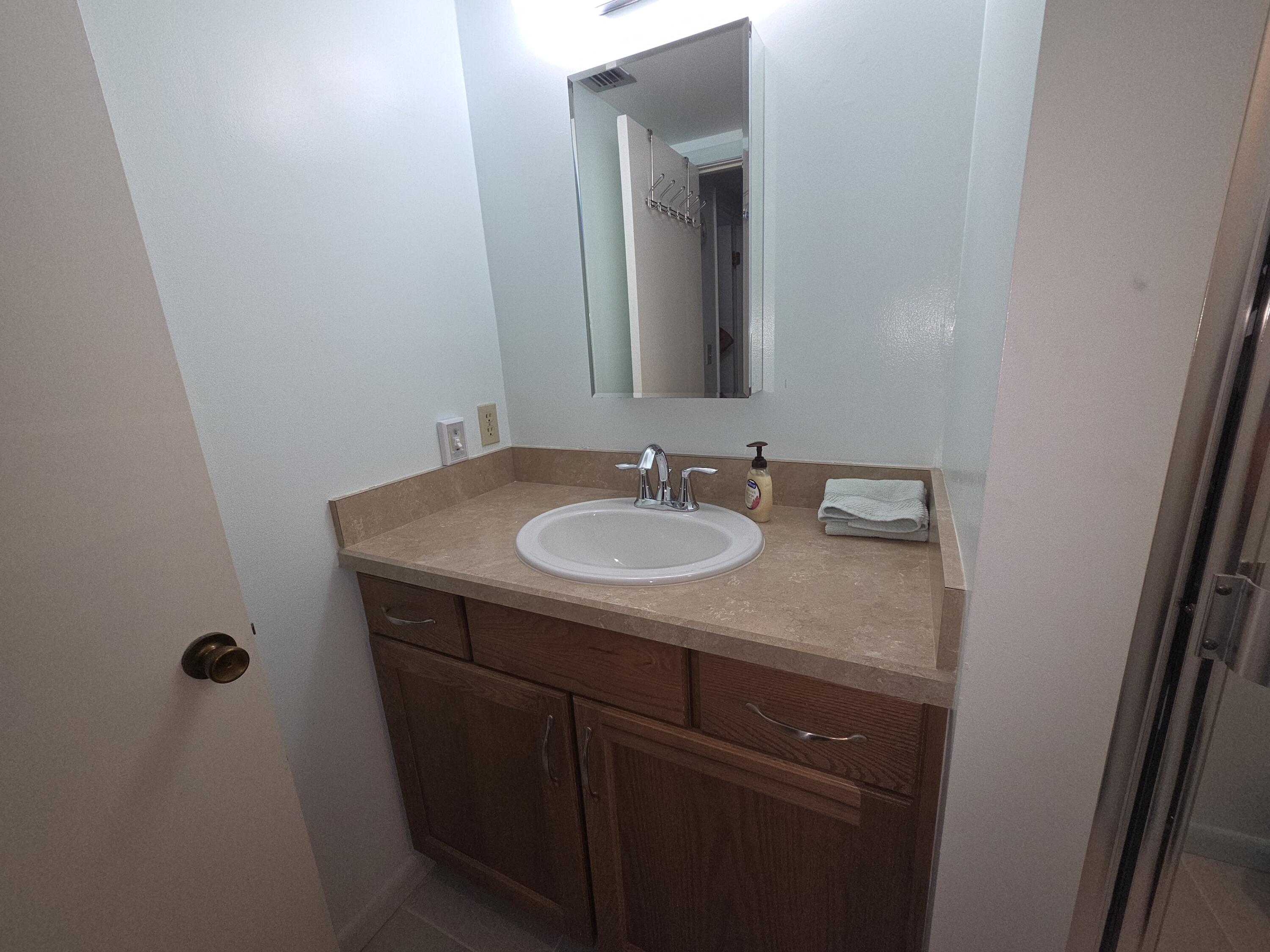 1170 6th Avenue, Unit 3A Vero Beach, FL 32960 - Photo 30 of 31 a sink and a mirror