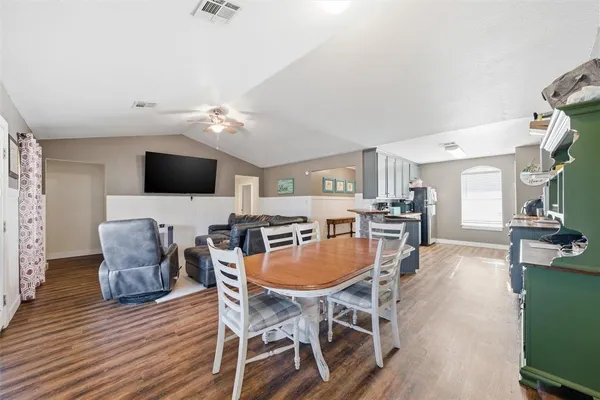 a view of a dining room with furniture and wooden floor