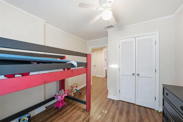 wooden floor with white walls and closet