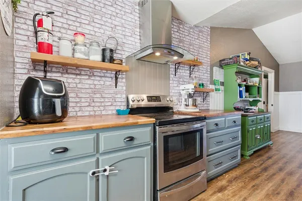 a kitchen with stainless steel appliances granite countertop a sink and a stove
