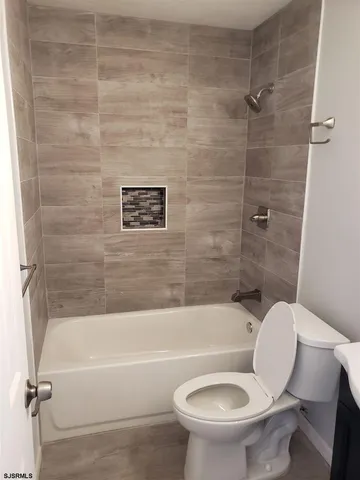 a bathroom with a toilet and a bath tub