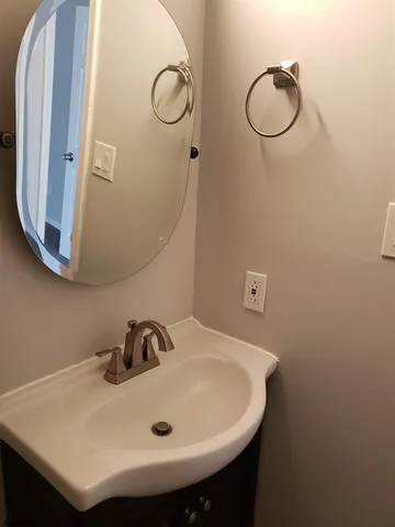 a bathroom with a sink and mirror