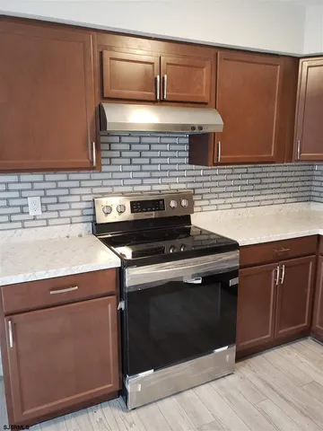 a kitchen with a stove and a sink