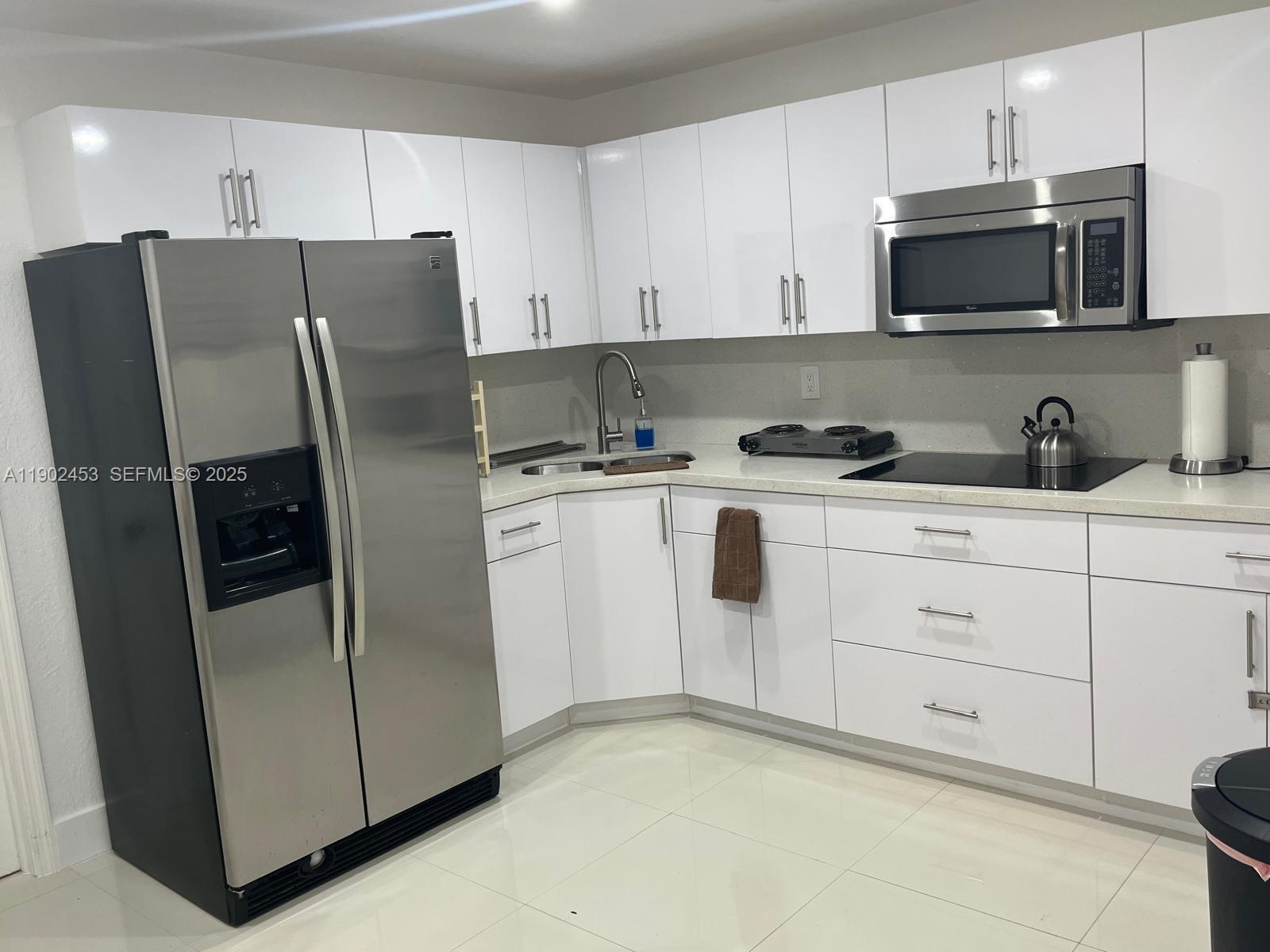 351 East 35th Street Hialeah, FL 33013 - Photo 2 of 4 a kitchen with stainless steel appliances white cabinets and a refrigerator