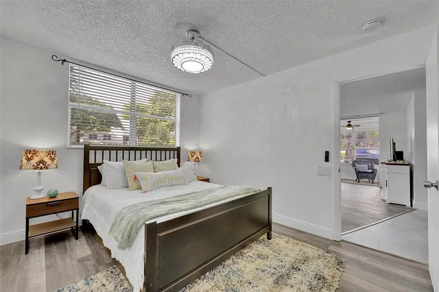 a bedroom with a bed and a large window