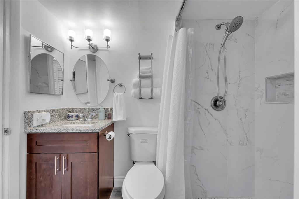 9090 Lime Bay Boulevard, Unit 112 Tamarac, FL 33321 - Photo 20 of 55 a bathroom with a granite countertop sink toilet and shower