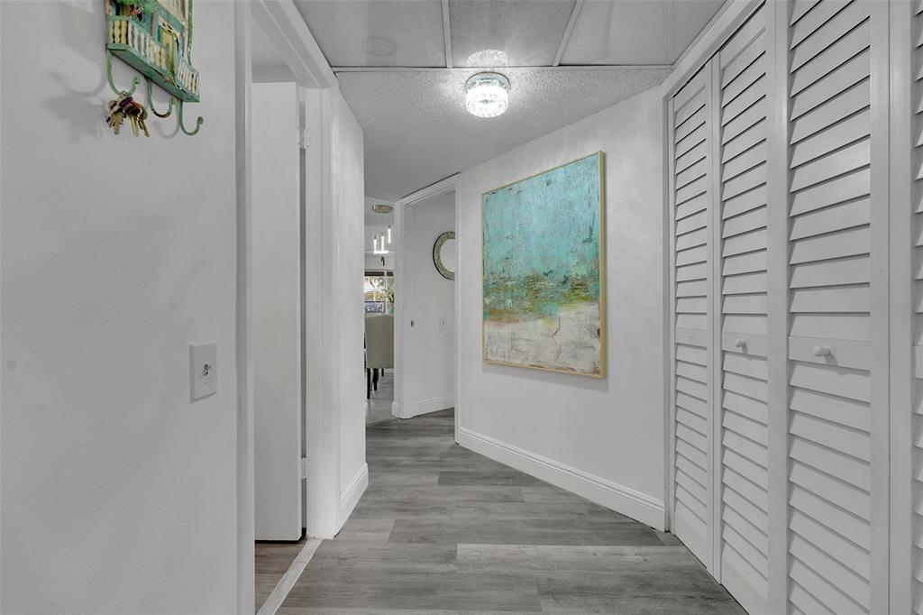 9090 Lime Bay Boulevard, Unit 112 Tamarac, FL 33321 - Photo 2 of 55 a view of hallway with window and wooden floor