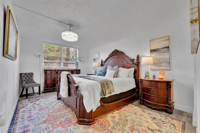 a bed room with a bed and a chandelier