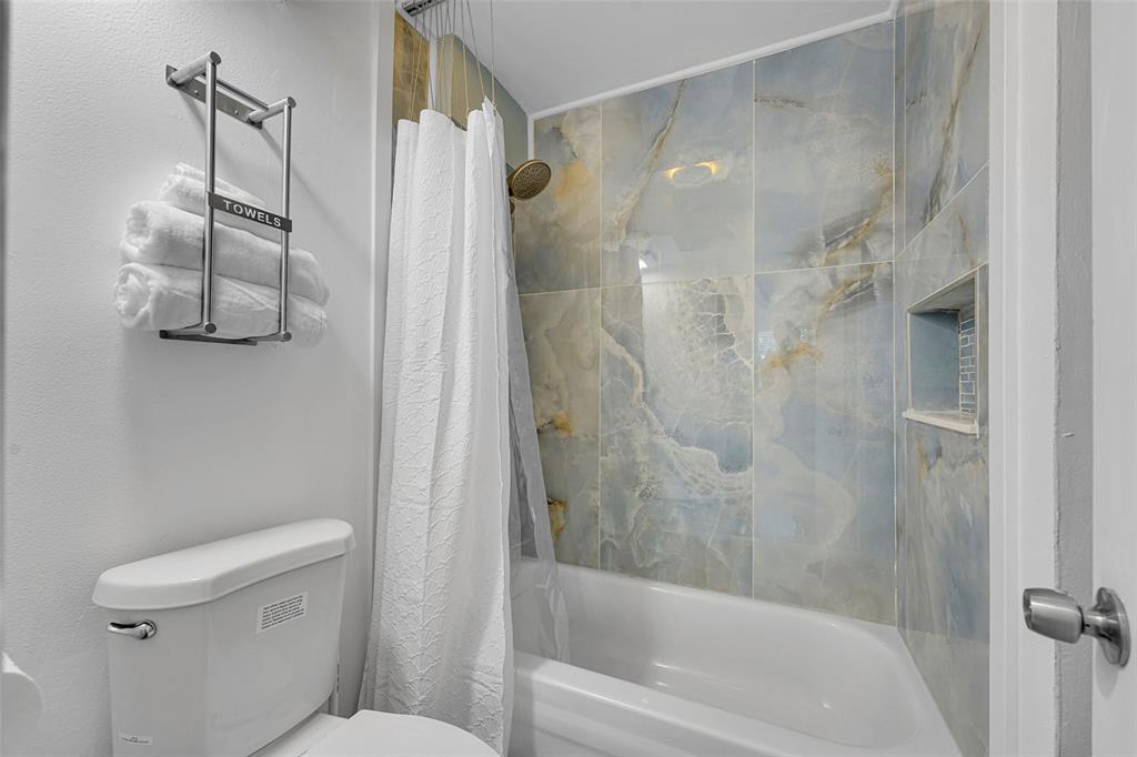 9090 Lime Bay Boulevard, Unit 112 Tamarac, FL 33321 - Photo 26 of 55 a bathroom with a shower and a toilet