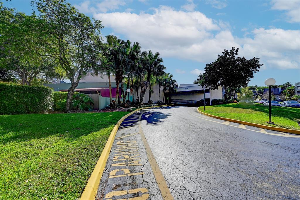 9090 Lime Bay Boulevard, Unit 112 Tamarac, FL 33321 - Photo 34 of 55 a view of a park with large trees