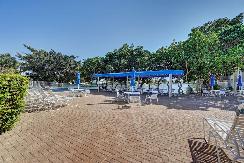 9090 Lime Bay Boulevard, Unit 112 Tamarac, FL 33321 - Photo 35 of 55 a view of a swimming pool with a patio