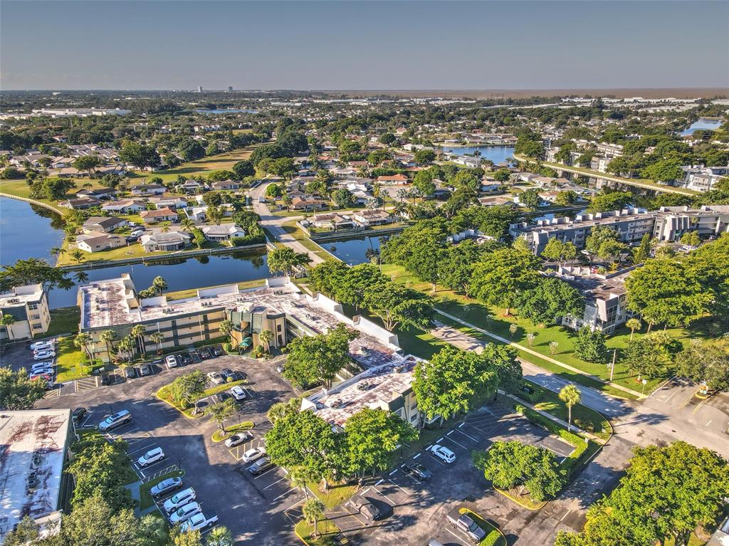 9090 Lime Bay Boulevard, Unit 112 Tamarac, FL 33321 - Photo 46 of 55 an aerial view of residential building and parking space