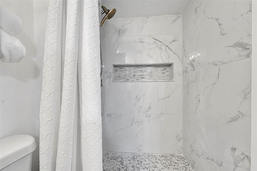 9090 Lime Bay Boulevard, Unit 112 Tamarac, FL 33321 - Photo 5 of 55 a bathroom with a shower
