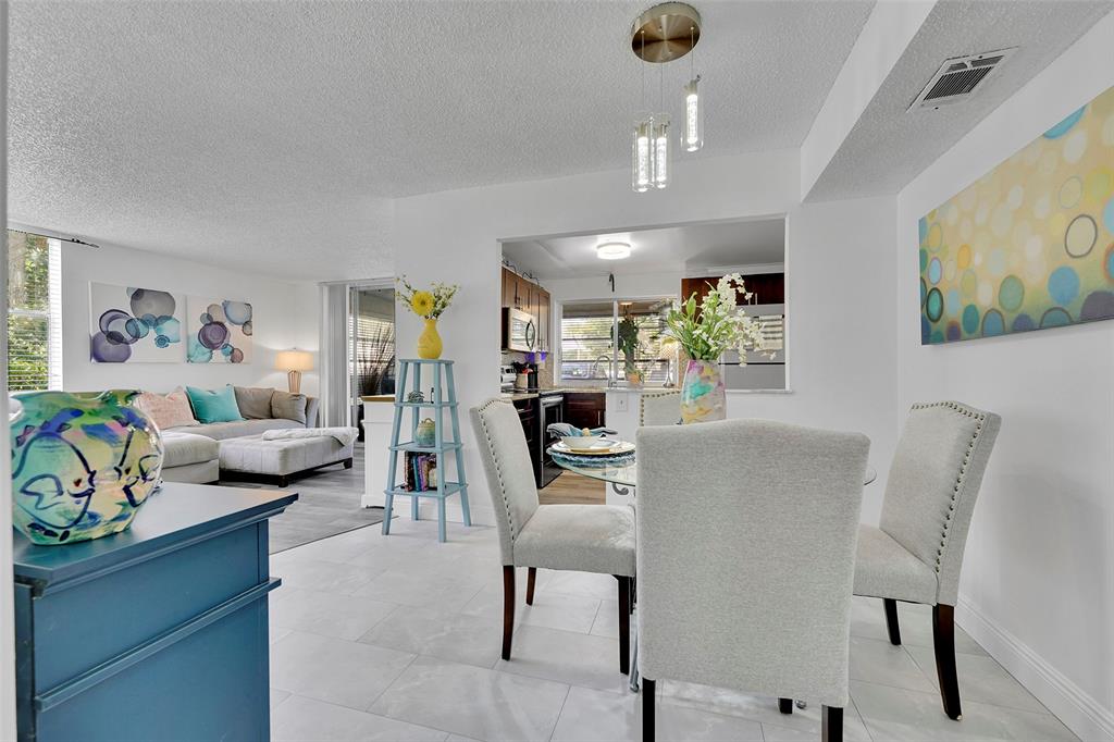 9090 Lime Bay Boulevard, Unit 112 Tamarac, FL 33321 - Photo 6 of 55 a living room with furniture and wooden floor