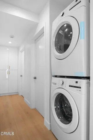 an empty room with windows and closet