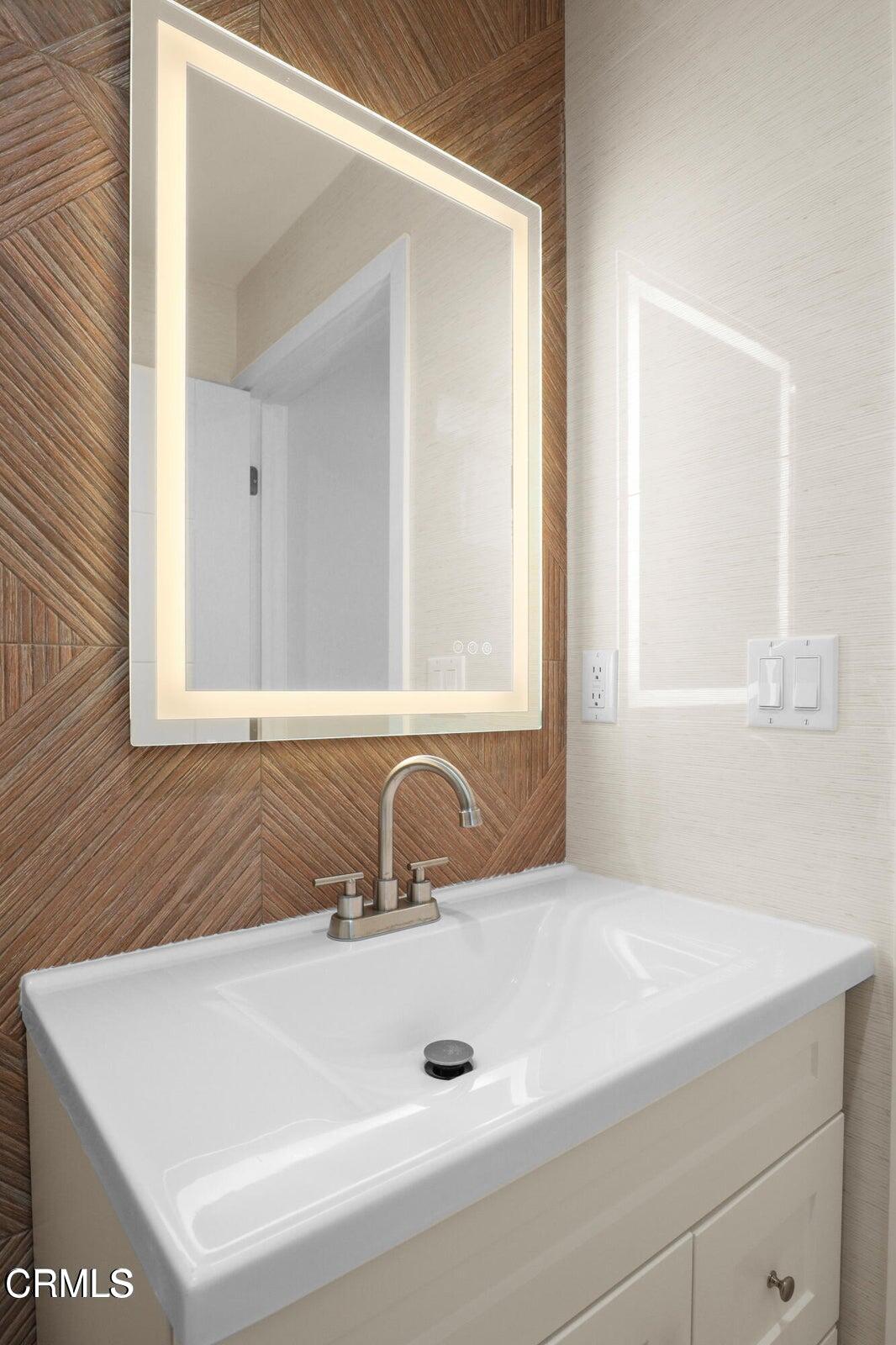 112 North Kenneth Road, Unit 101 Burbank, CA 91501 - Photo 15 of 20 a bathroom with a sink and a mirror