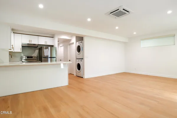 a kitchen with a refrigerator sink stove and refrigerator