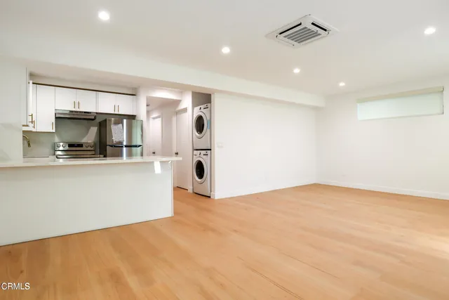 a kitchen with a refrigerator sink stove and refrigerator