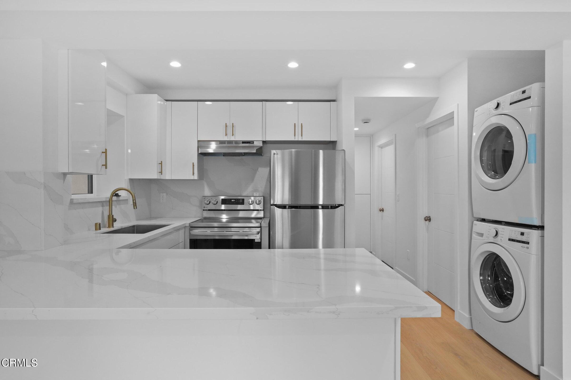 112 North Kenneth Road, Unit 101 Burbank, CA 91501 - Photo 9 of 20 a kitchen with stainless steel appliances granite countertop a sink a stove a refrigerator and cabinets