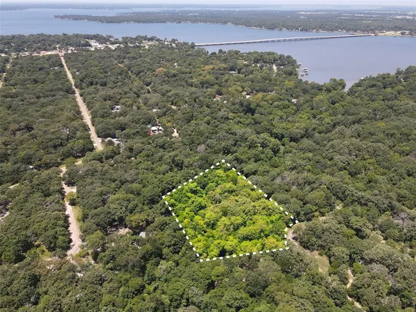 an aerial view of a houses with a yard