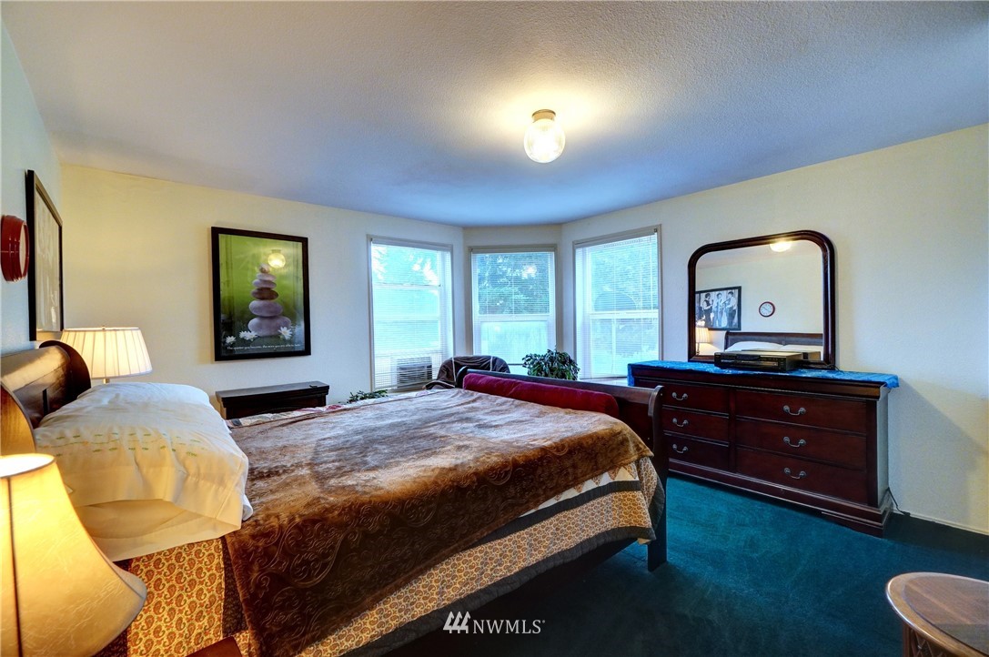 4908 183rd Avenue Southwest Rochester, WA 98579 - Photo 14 of 38 a bedroom with a bed and a dresser with mirror