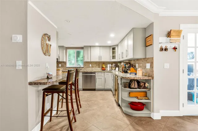 a kitchen with refrigerator cabinets and window