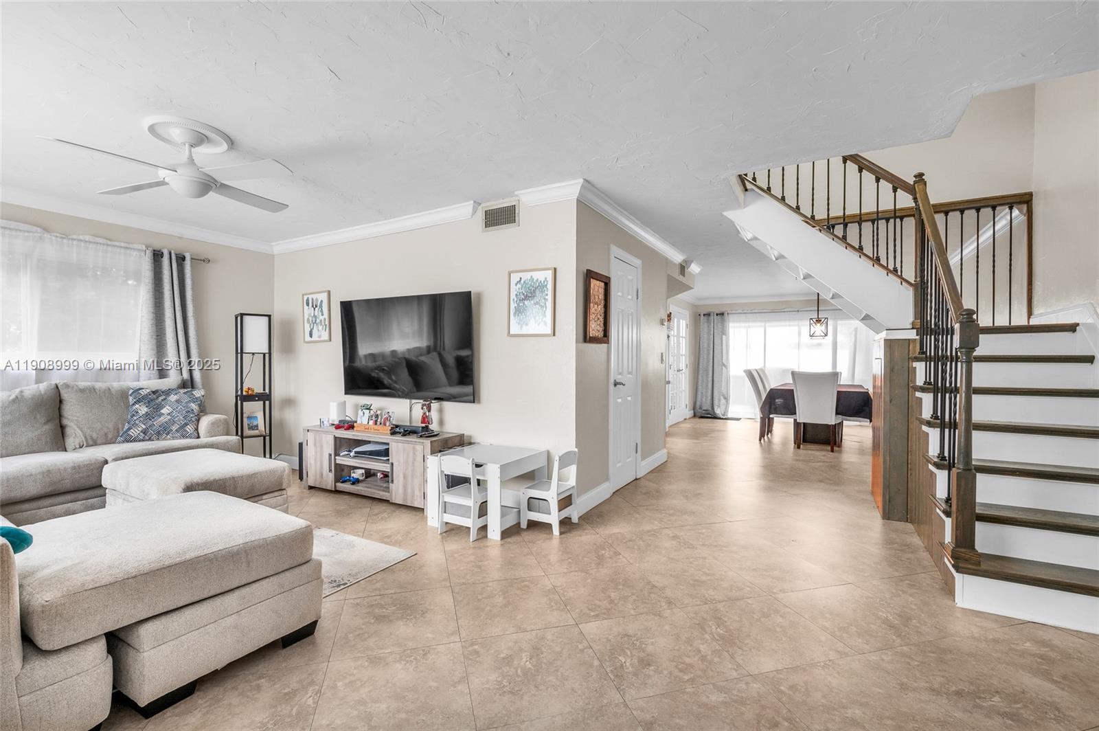 6797 Southwest 40th Street, Unit 71 Davie, FL 33314 - Photo 2 of 35 a living room with furniture and a flat screen tv