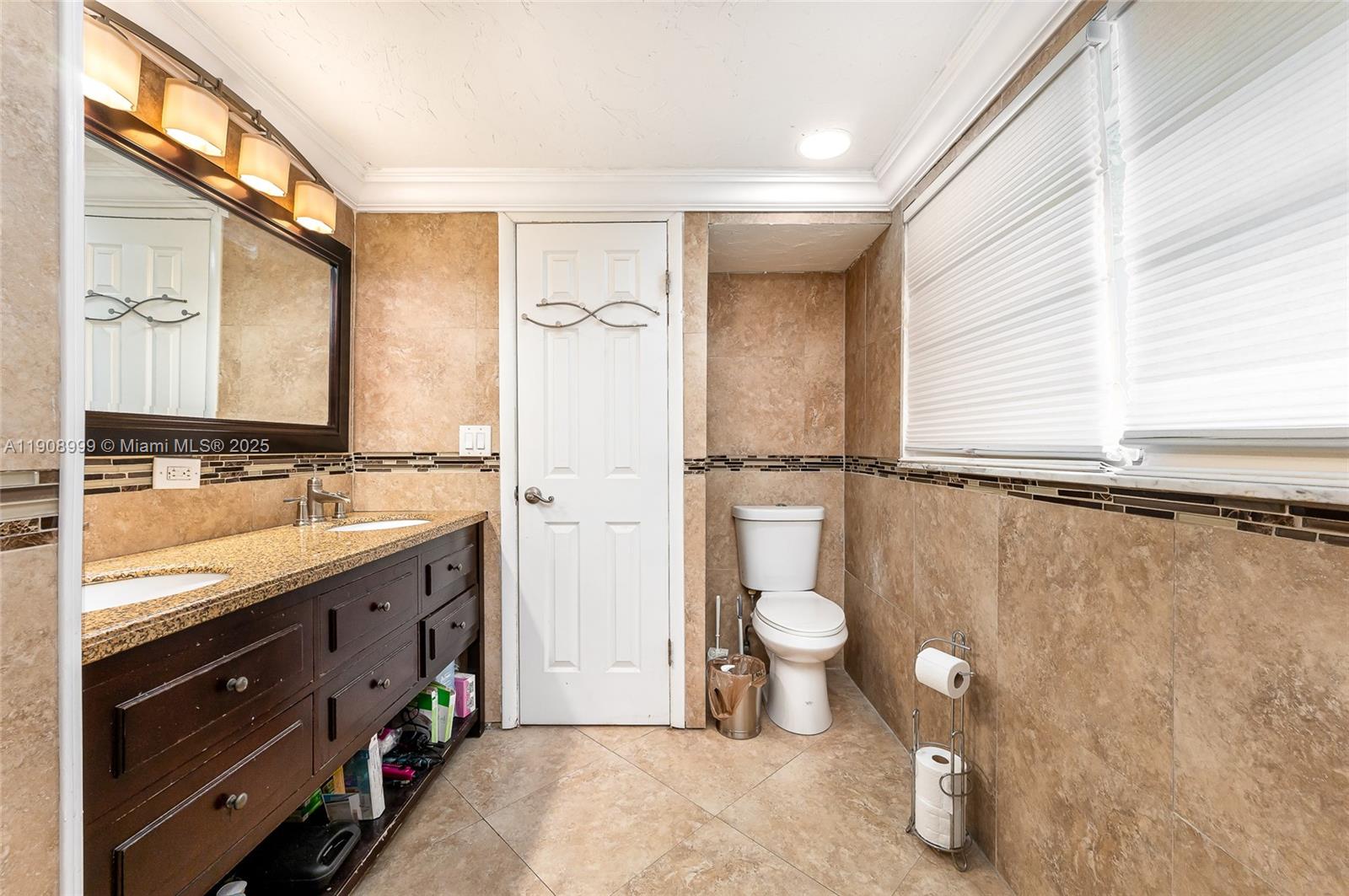6797 Southwest 40th Street, Unit 71 Davie, FL 33314 - Photo 22 of 35 a bathroom with a granite countertop sink toilet and shower