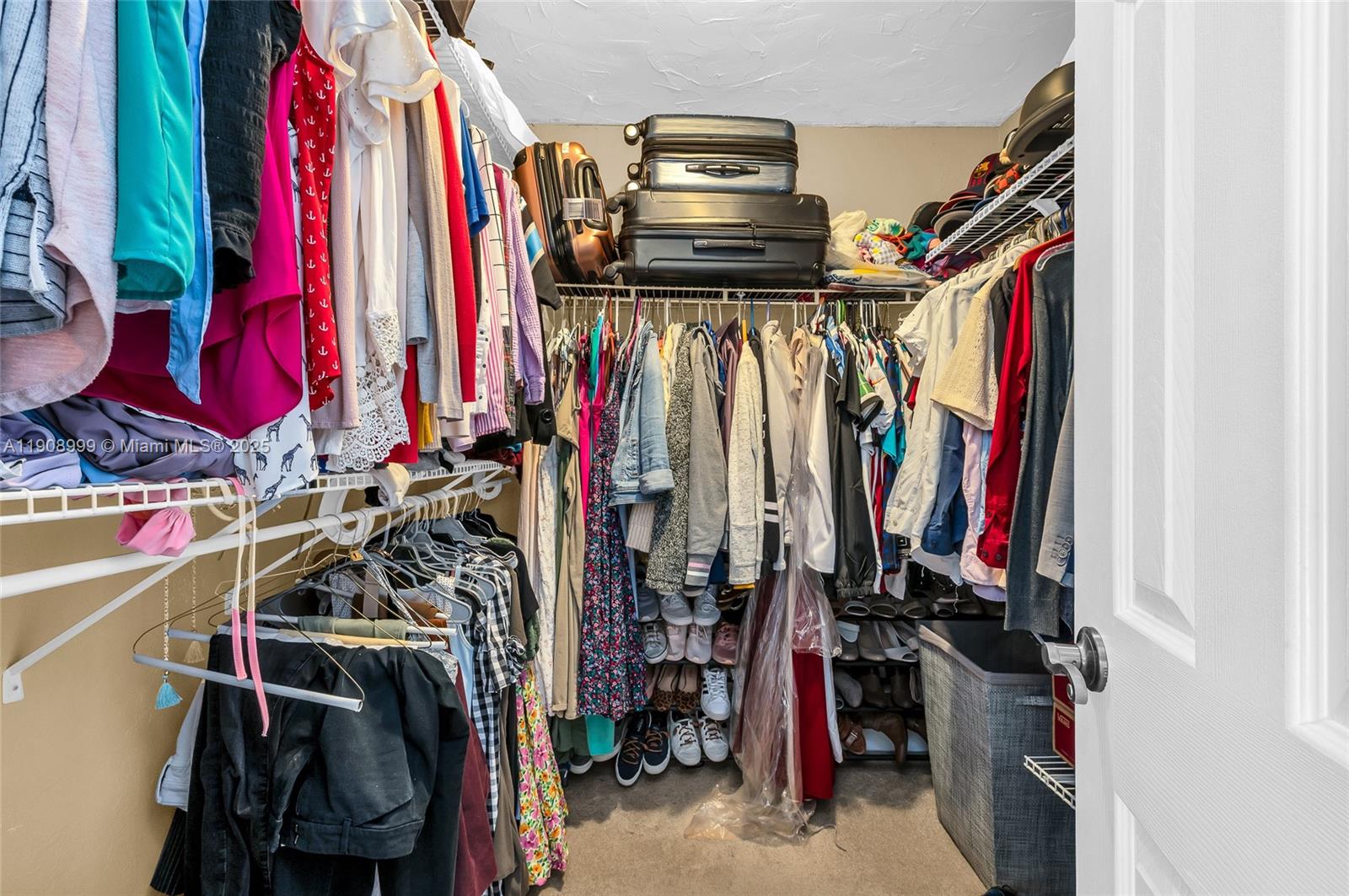 6797 Southwest 40th Street, Unit 71 Davie, FL 33314 - Photo 28 of 35 a view of a walk in closet with clothes