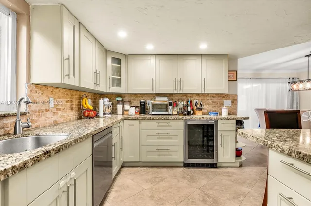 a kitchen with stainless steel appliances granite countertop a stove sink and cabinets