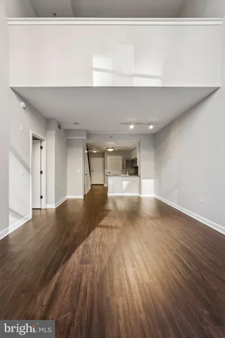 a view of empty room with wooden floor