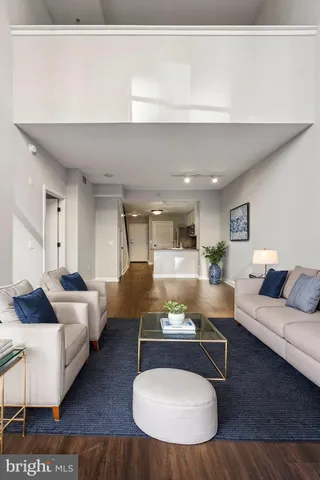 a living room with furniture and a wooden floor