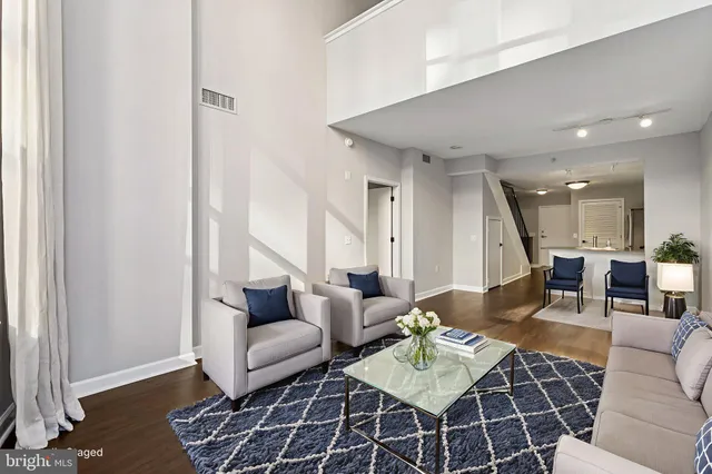 a living room with furniture and a rug