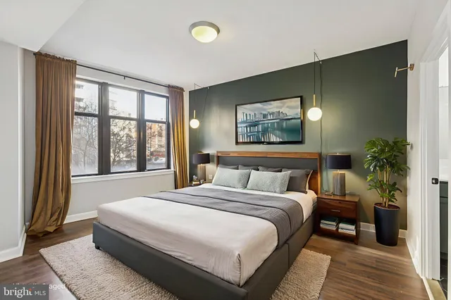 a bedroom with a large bed and a large window