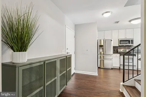 a kitchen with stainless steel appliances a refrigerator and a stove top oven