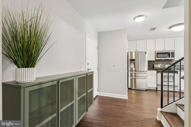 a kitchen with stainless steel appliances a refrigerator and a stove top oven
