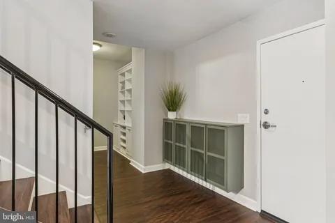 a view of front door with wooden floor and stairs