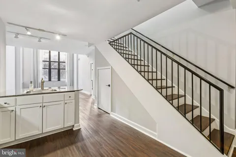 a view of entryway with wooden floor and stairs