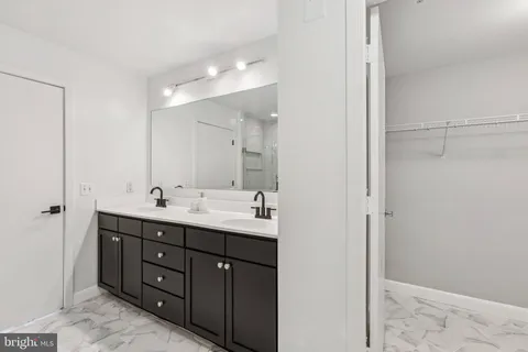 a bathroom with a double vanity sink and mirror
