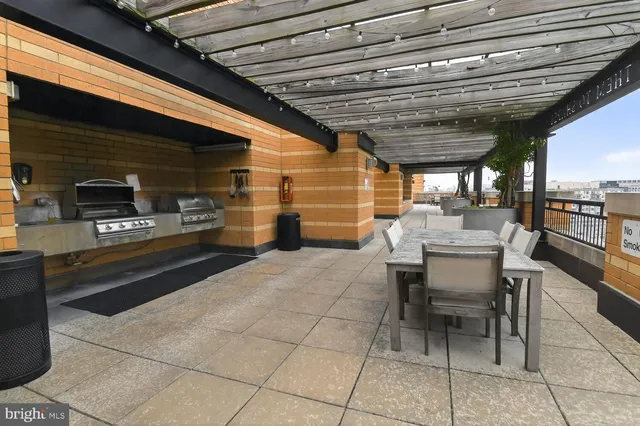 a view of a patio with table and chairs