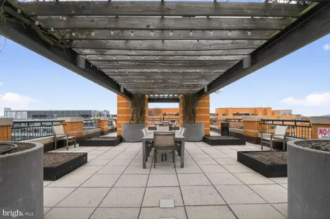 a living room with patio furniture and a view of swimming pool