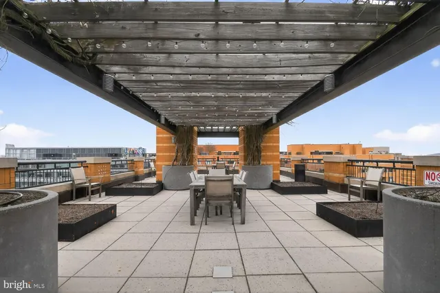 a living room with patio furniture and a view of swimming pool