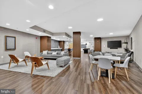 a view of a dining room with furniture wooden floor and a rug