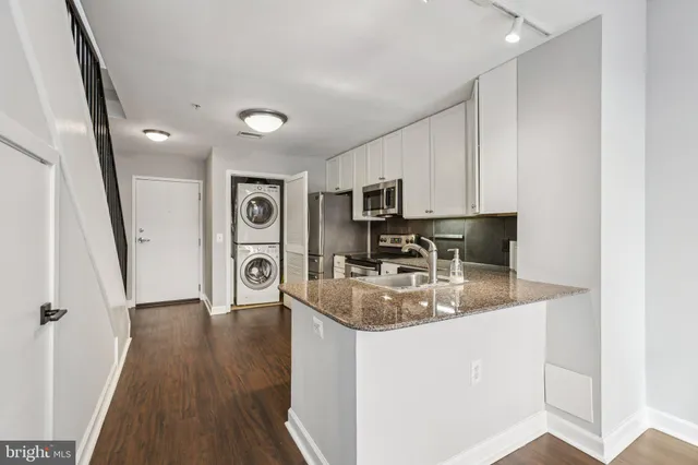 a kitchen with sink refrigerator and microwave