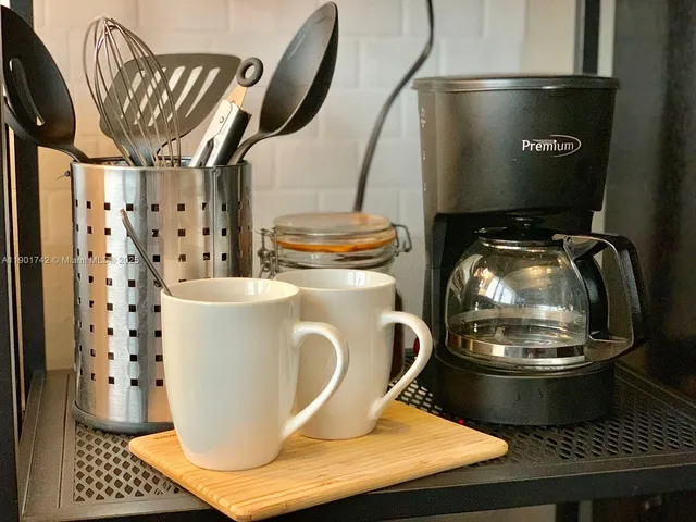 a kitchen with a sink a stove and a microwave