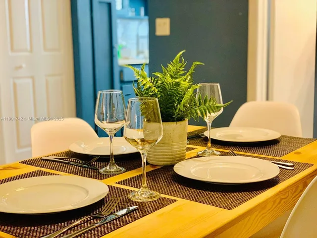 a view of a dining room with furniture and a potted plant