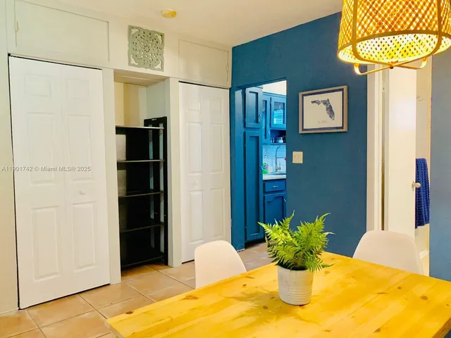 a kitchen with a sink and a wooden floor