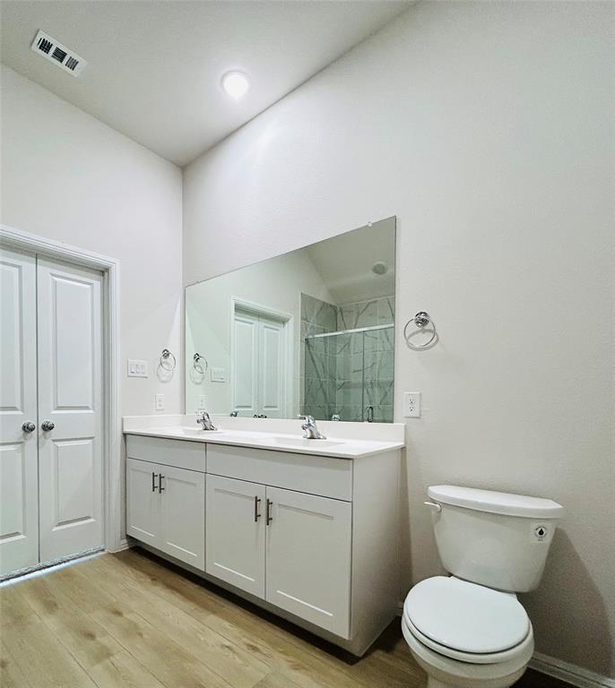 2505 McNally Drive Mesquite, TX 75181 - Photo 16 of 28 a spacious bathroom with a toilet a sink and mirror